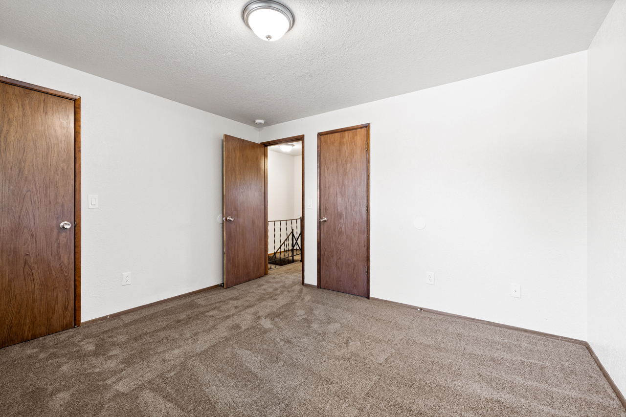 Upstairs bedroom with carpet and closet